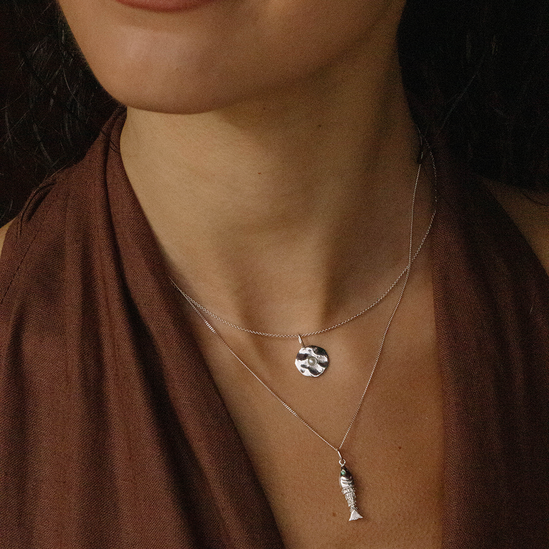 Colar com medalha de prata 925 com banho de ródio e pérola em modelo.