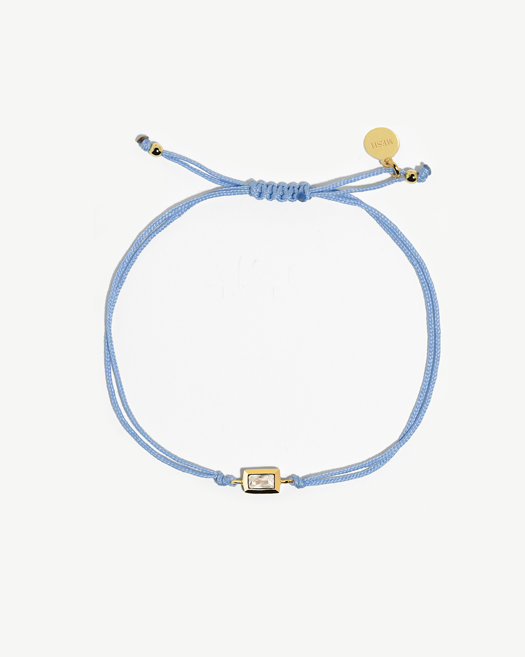 Pulseira ajustável de algodão com detalhe de prata 925 com banho de ouro 18K e zircónia.