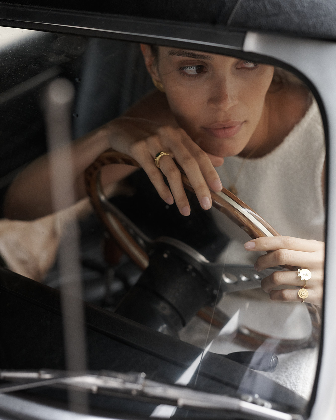 Anel com relevos em prata 925 e banho de ouro 18K com zircónia cúbica oval central em modelo.