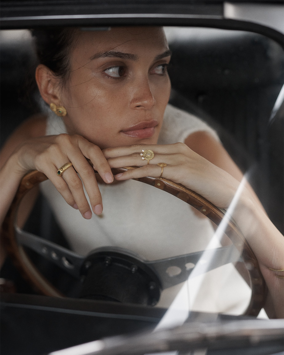 Anel com relevos em prata 925 e banho de ouro 18K com zircónia cúbica oval central em modelo.