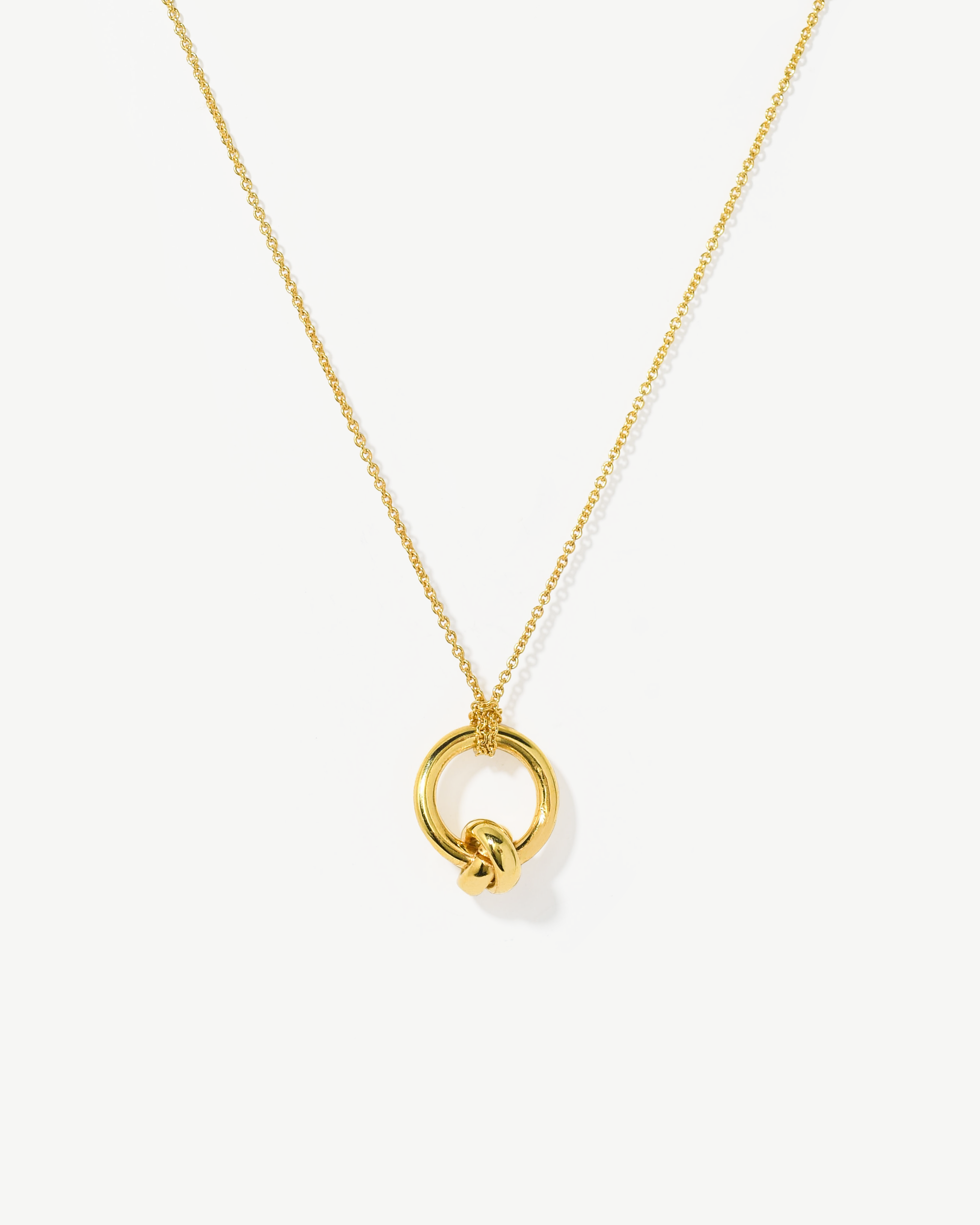 Colar com pendente de nó em prata dourada.