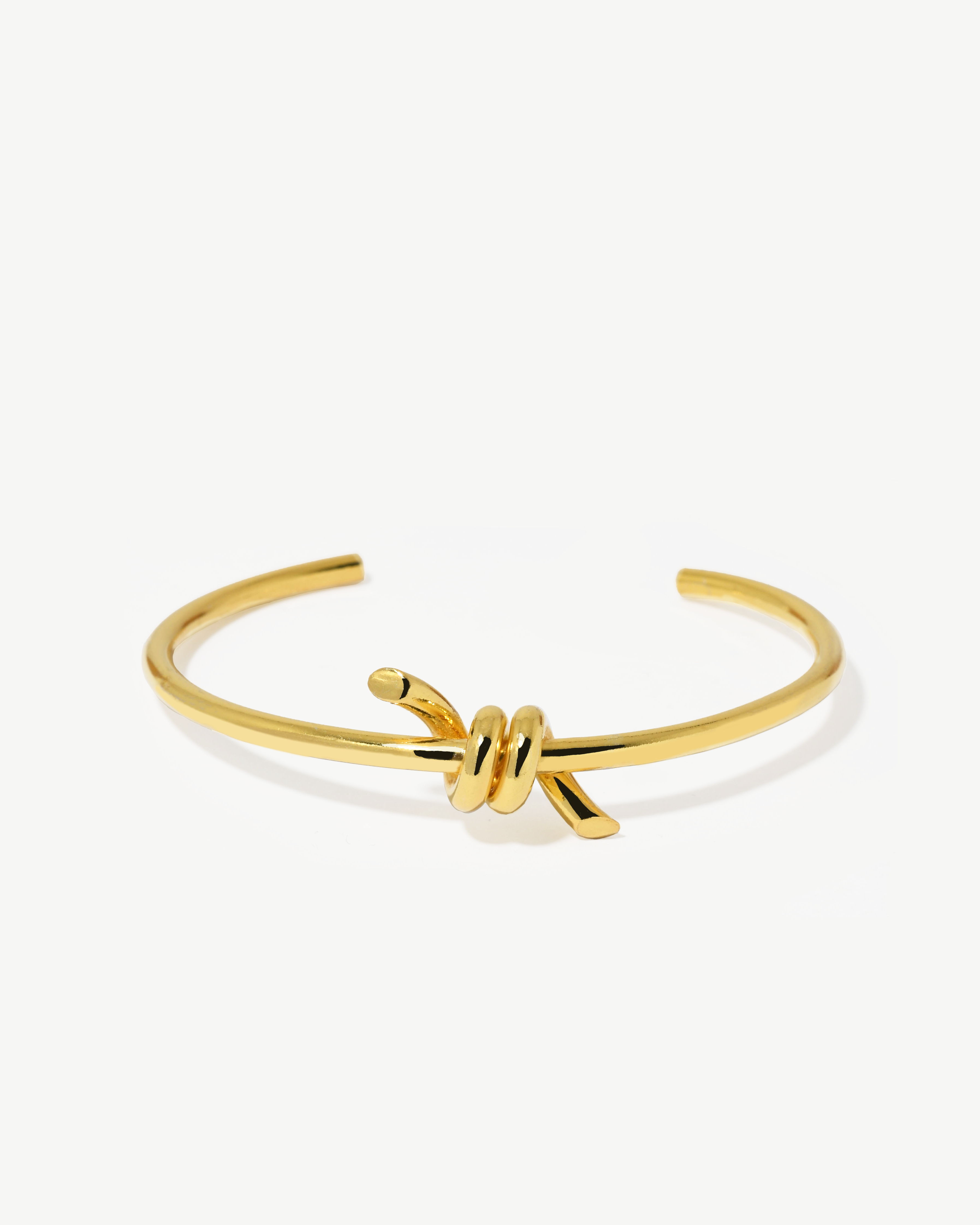 Escrava com detalhe em nó de prata dourada.