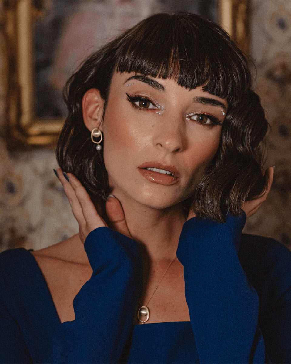 Brincos dourados com pérola